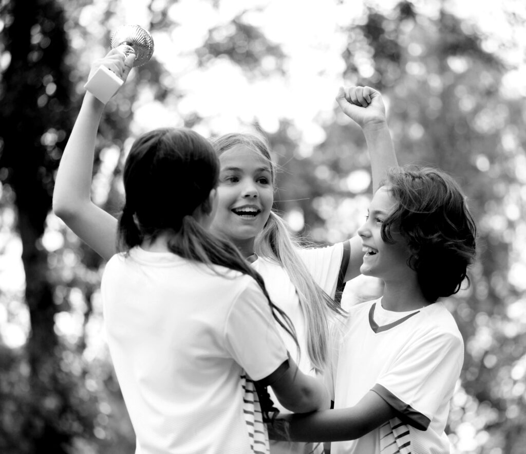 3 enfants célébrant une victoire sportive